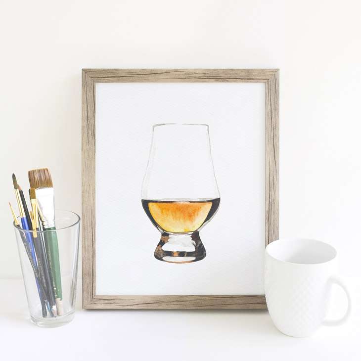 Image of a framed painting of a scotch glass with a pour of scotch.