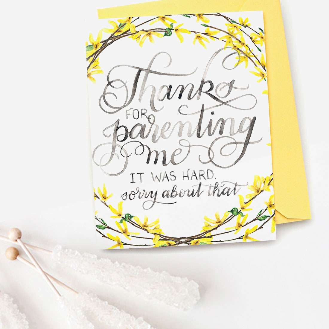 Image of a hand-lettered watercolor card saying "Thanks for parenting me... it was hard... sorry about that" with painted forsythia branches by CharmCat | charmcat.net
