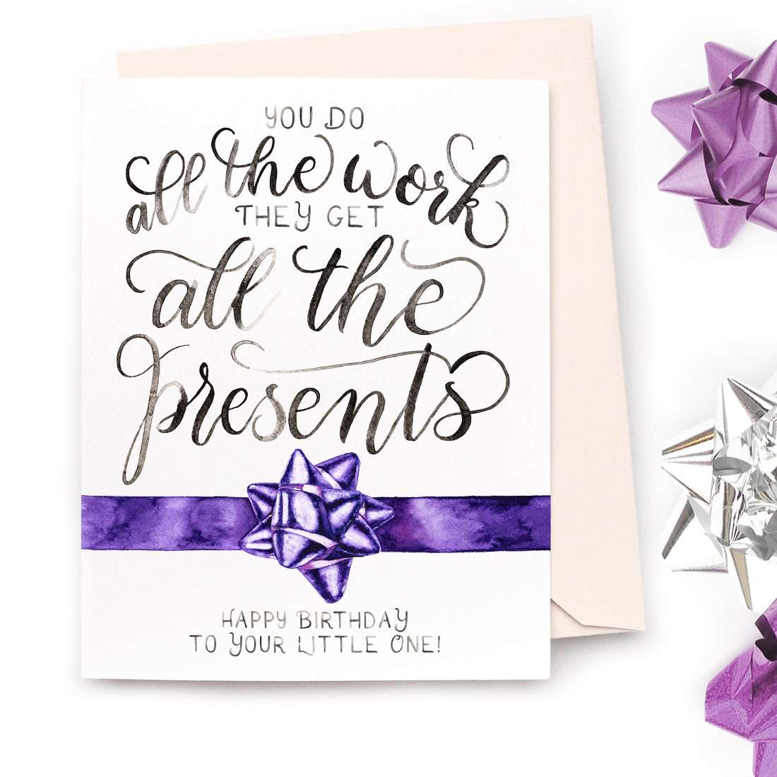 Image of a hand-lettered watercolor card saying "you do all the work, they get all the presents... happy birthday to your little one" with a painted gift bow by CharmCat | charmcat.net