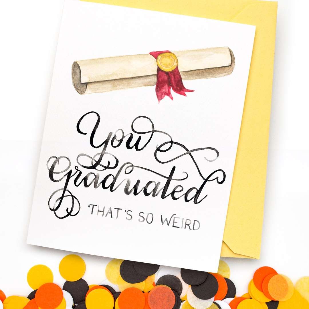 Image of a hand-lettered watercolor card saying "You Graduated... that's so weird" with rolled up diploma with red ribbon and gold seal by CharmCat | charmcat.net