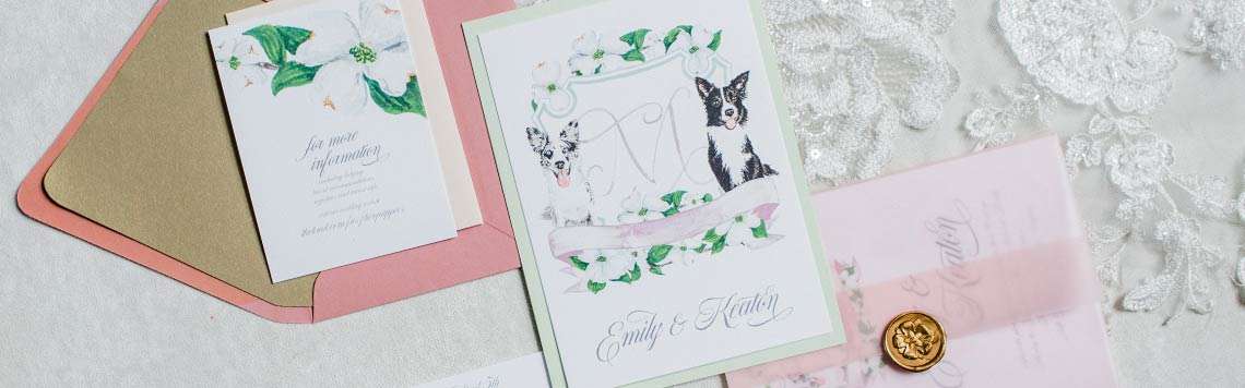 Photo of a custom wedding invitation featuring watercolor lettering, watercolor dog portraits , and a watercolor crest.