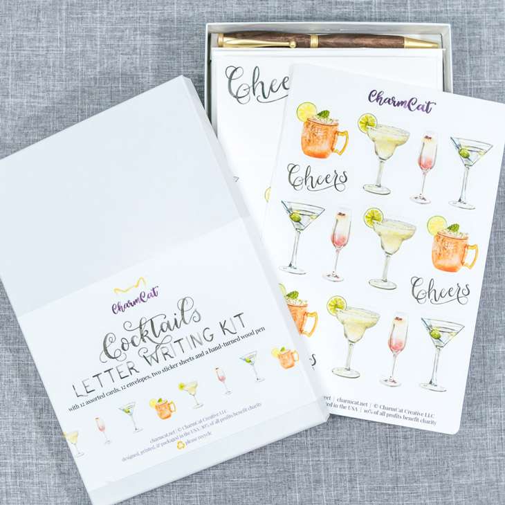 The Cocktails Letter Writing Kit, box slightly open, showing the sticker sheet first thing inside the box.